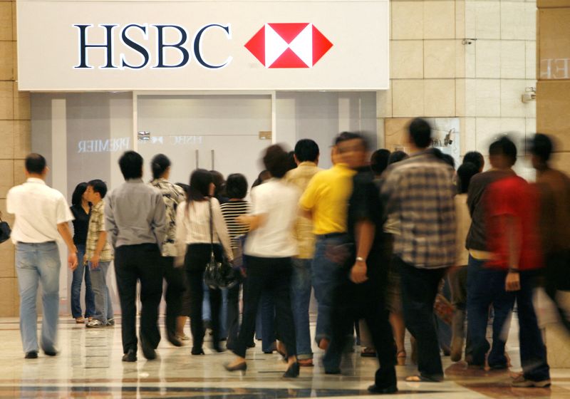 FILE PHOTO: People walk in front of the headquarters for HSBC Bank in Jakarta